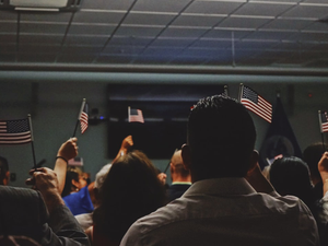 people holding flag of U.S.A miniature