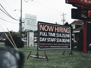 a sign in the grass advertising a job fair