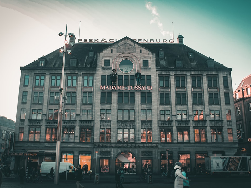 a large building with people walking around in front of it