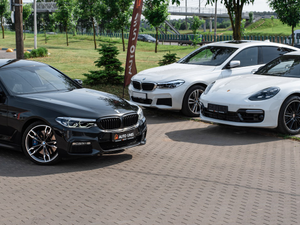 a group of cars parked on a brick road