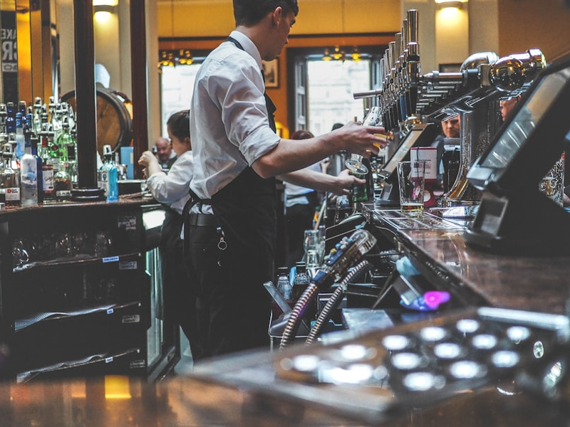man preparing beverage drink in bar