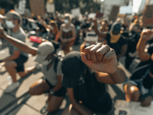 A fist raised in solidarity for George Floyd (IG: @clay.banks)