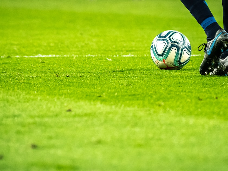 man playing soccer game on field