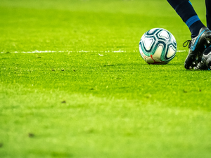 man playing soccer game on field