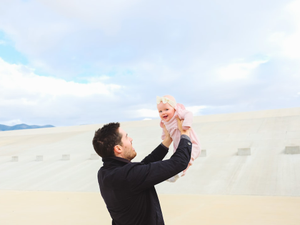 man carrying baby during daytime