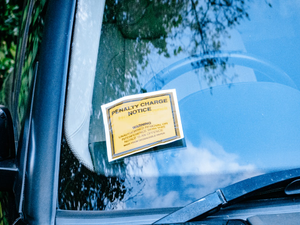 a car with a yellow sign attached to it's side window
