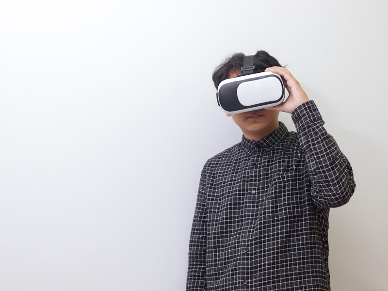 Asian man using Virtual Reality VR glasses and playing games