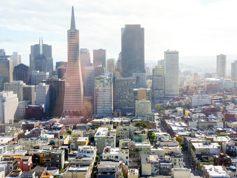 aerial photography of concrete buildings under blue cloudy sky