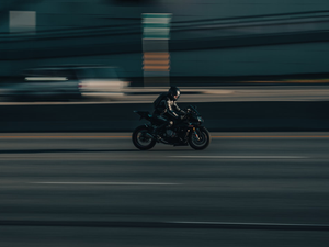 a person riding a motorcycle on a city street