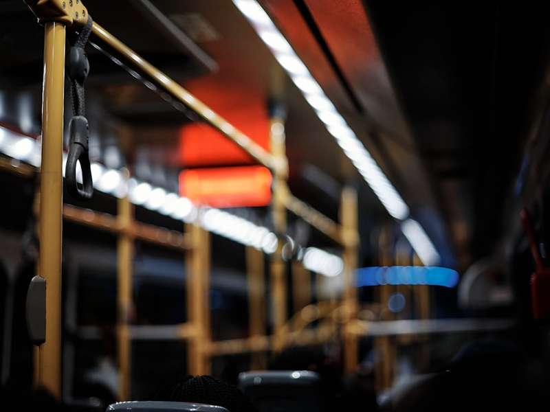 Lagos, Nigeria - 30.11.2021: Shots of the interiors, Close up of hand holding a handgrip, and a watch your step sign on a BRT, a mass transit system in Lagos, Nigeria.