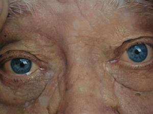 Close-up of an elderly person's blue eyes.