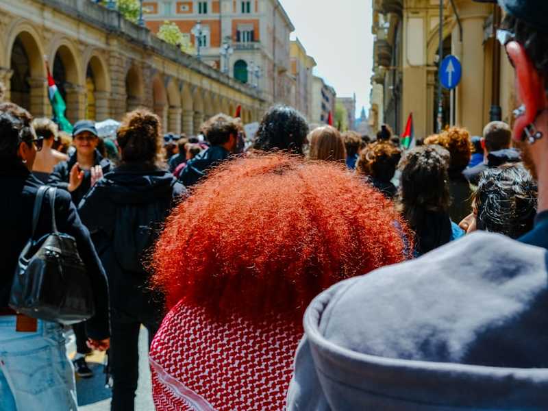 a crowd of people walking down a street