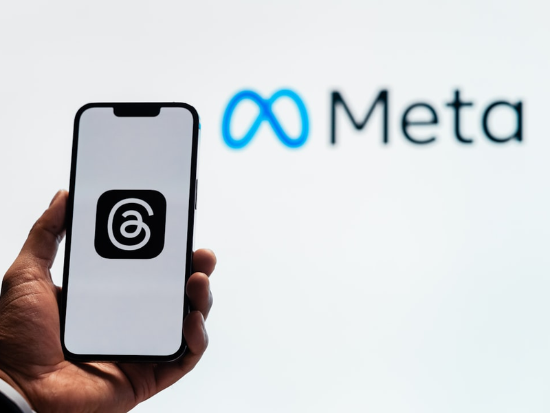 Young man using new meta threads app on smartphone