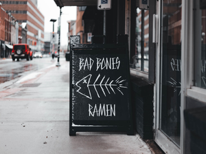 a sign on the side of a building that says bar bones and ramen