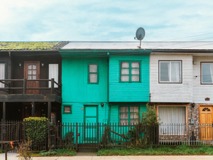 a row of multi - colored houses with a green roof