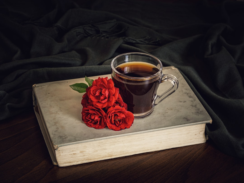 Tea, book and red flowers