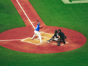 A baseball player holding a bat on top of a field