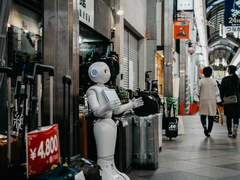 robot standing near luggage bags