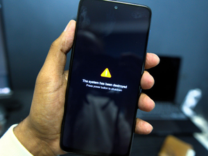 Phone shows a system failure warning message.