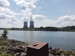 Nuclear plant cooling towers behind trash receptacle