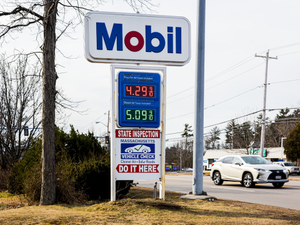 a mobil gas station sign next to a road
