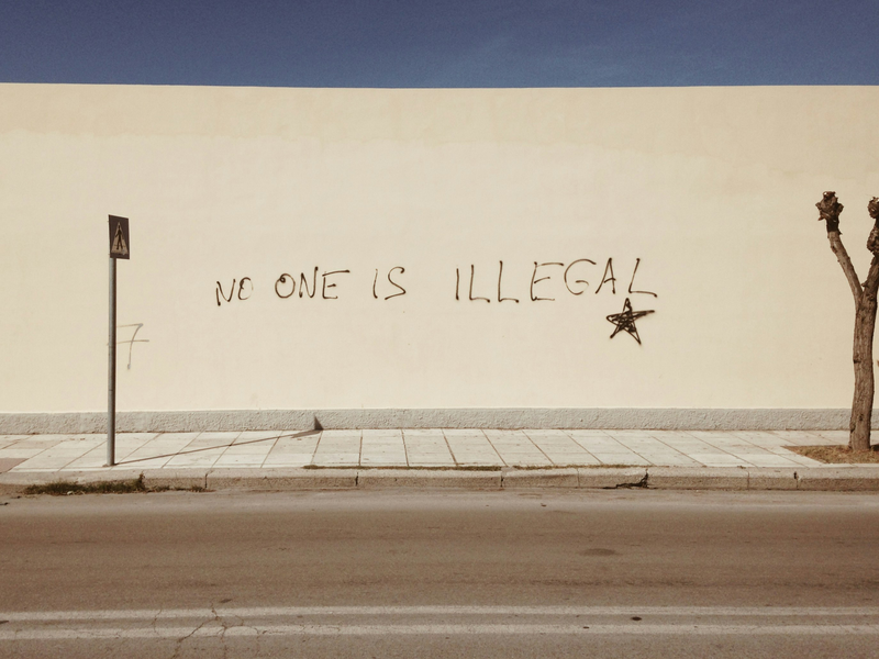 No One Is Illegal Phrase on a Wall