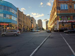 a street with cars and buildings on either side of it
