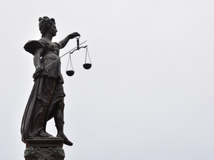 A statue of lady justice holding a scale of justice