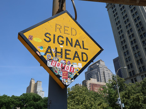 The sign warns of a red signal ahead.