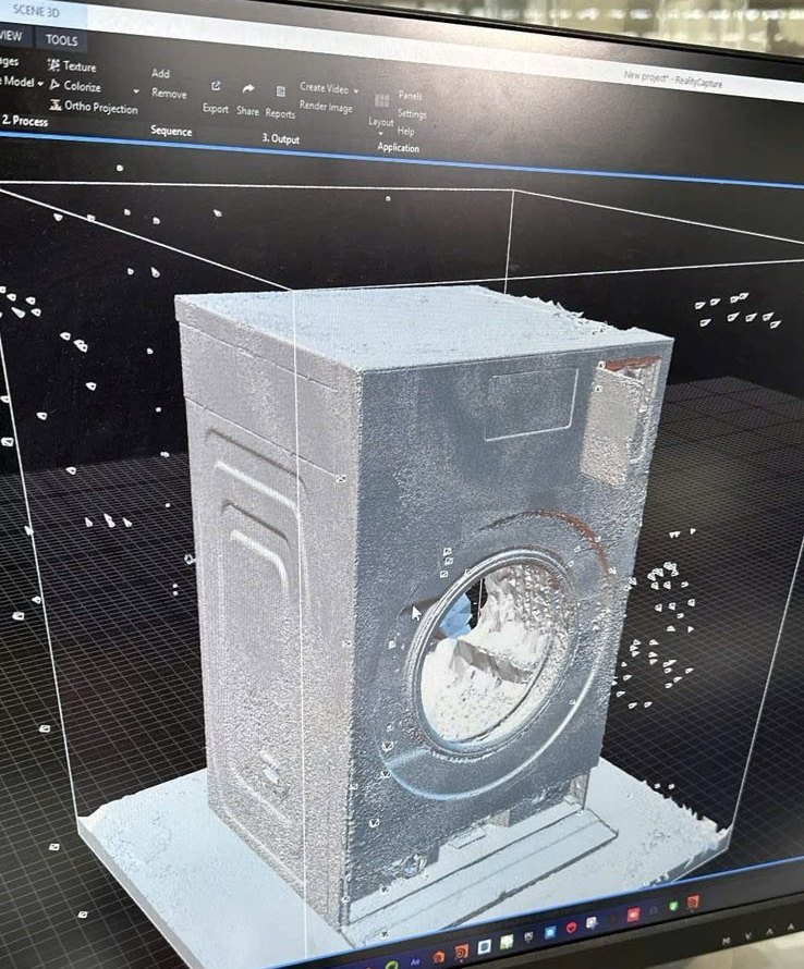 A washing machine rebuilt as a 3D model from photographs, shown in 3D software on a monitor