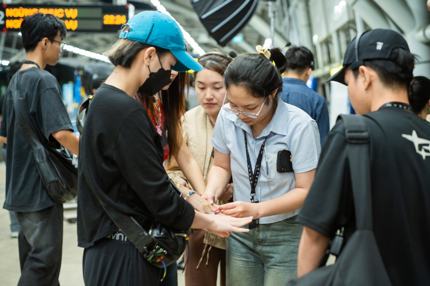 Crew and actors huddled over a plan on a metro platform during a Samsung Galaxy S24 shoot