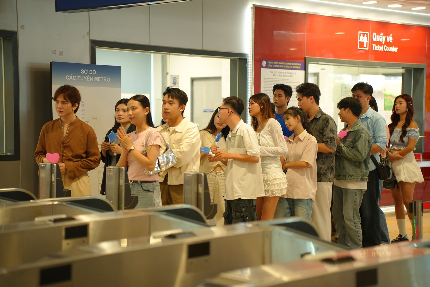 Extras queueing at metro ticket gates during a Samsung Wallet shoot