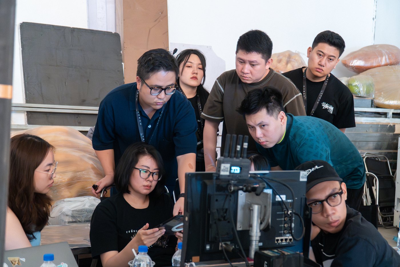Agency and crew crowded around the monitors on a Vaseline studio shoot