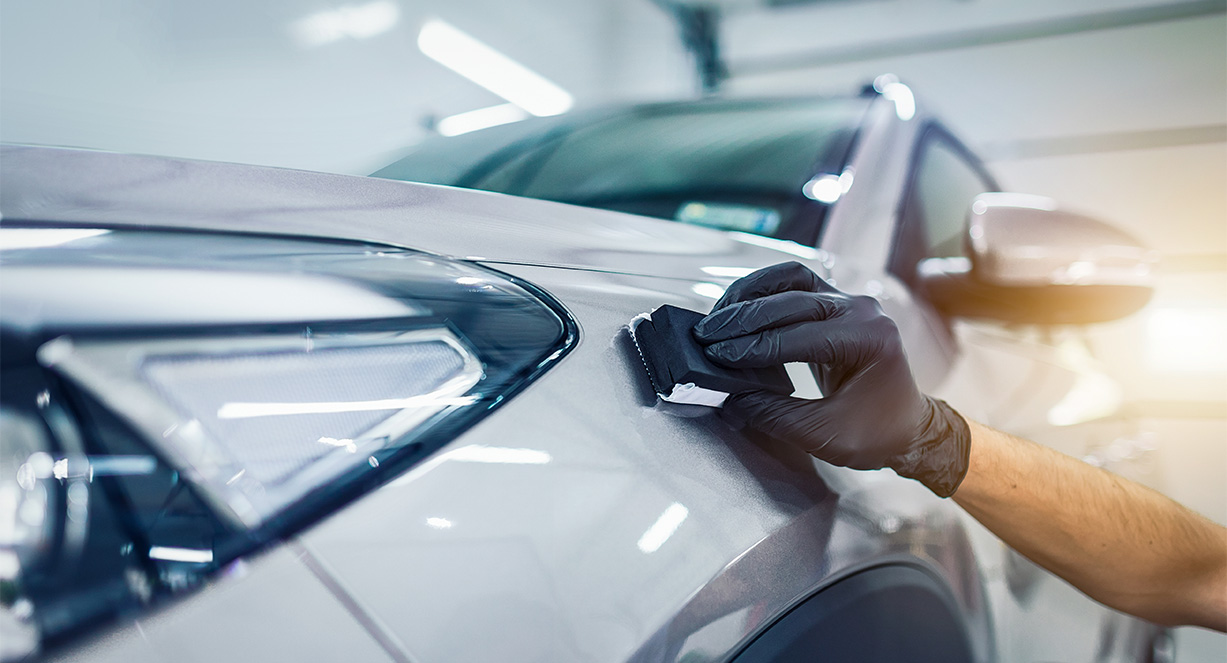 A car being coated with ceramic for long-lasting protection.