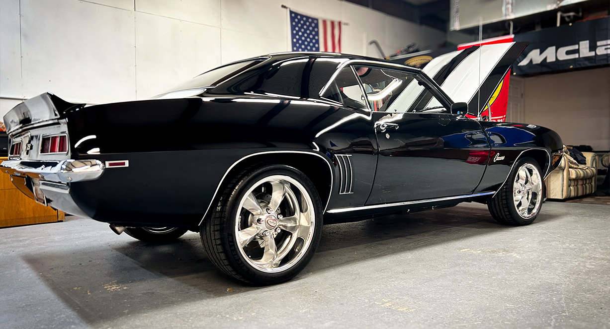 A classic car getting a professional paint correction service