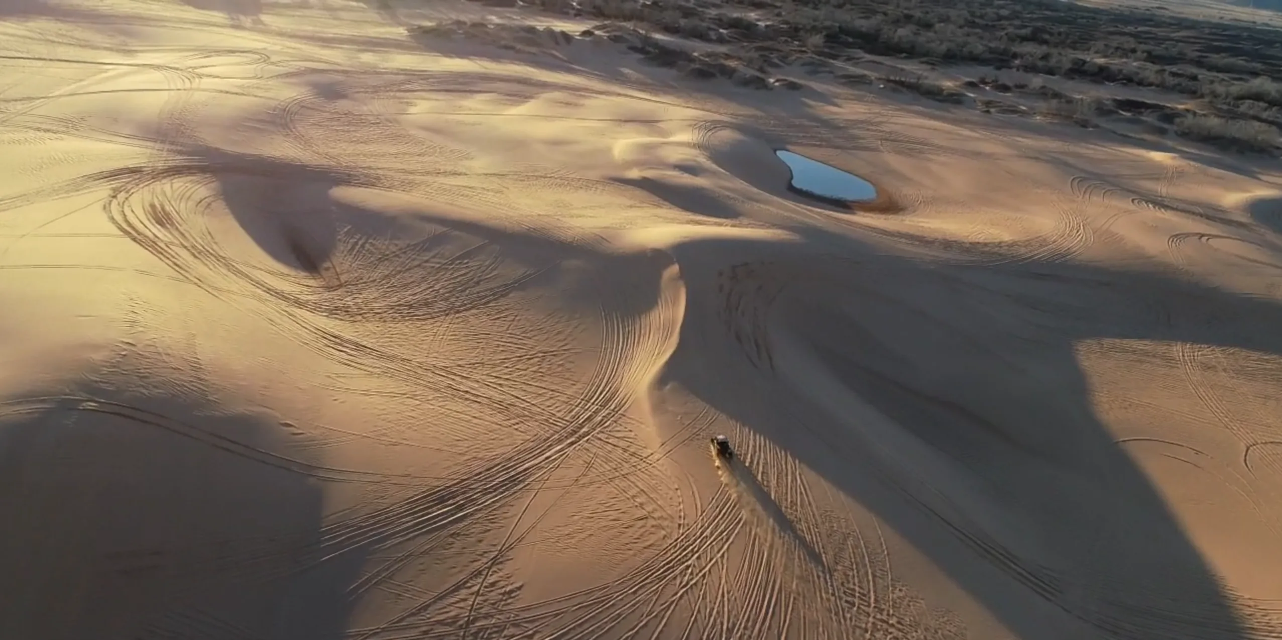 Aerial view of a brand new Polaris RZR driving across the Oklahoma Sand Dunes at Little Sahara State Park.