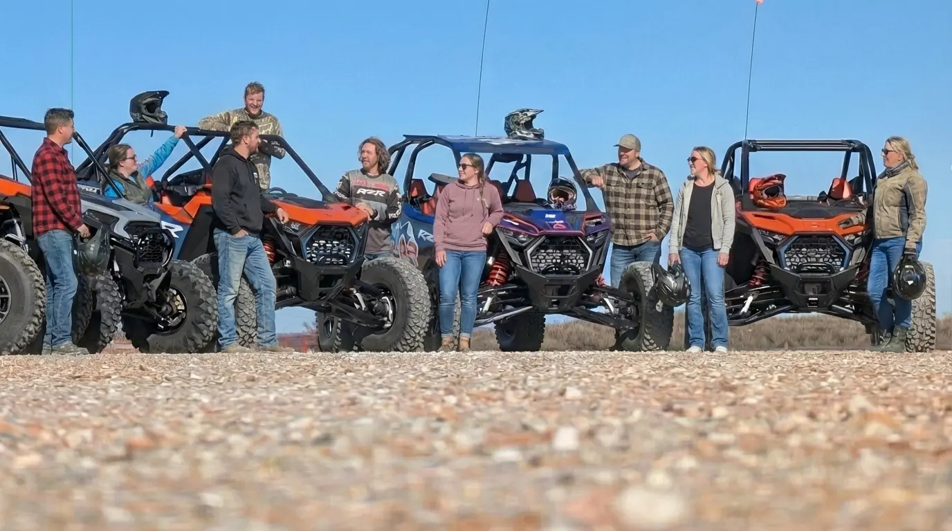 Group of friends standing with Polaris RZR rentals during an all-inclusive adventure weekend at Little Sahara State Park in Waynoka, OK.