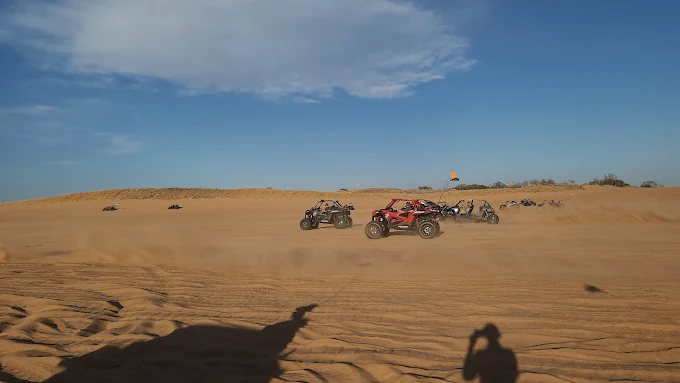 A group fleet of Polaris RZR rentals on the sand at Little Sahara State Park, showcasing the perfect setup for large group trips from Amarillo, TX.