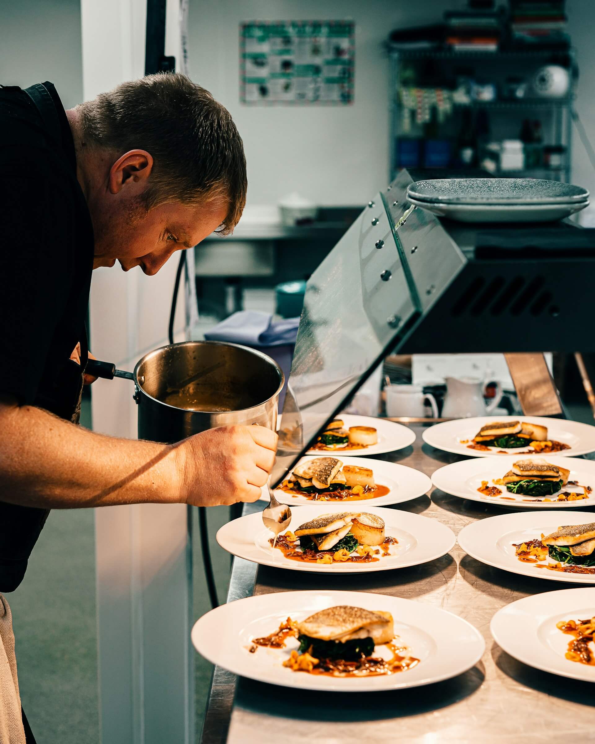 A chef meticulously plating a dish, showcasing the artistry of fine dining.