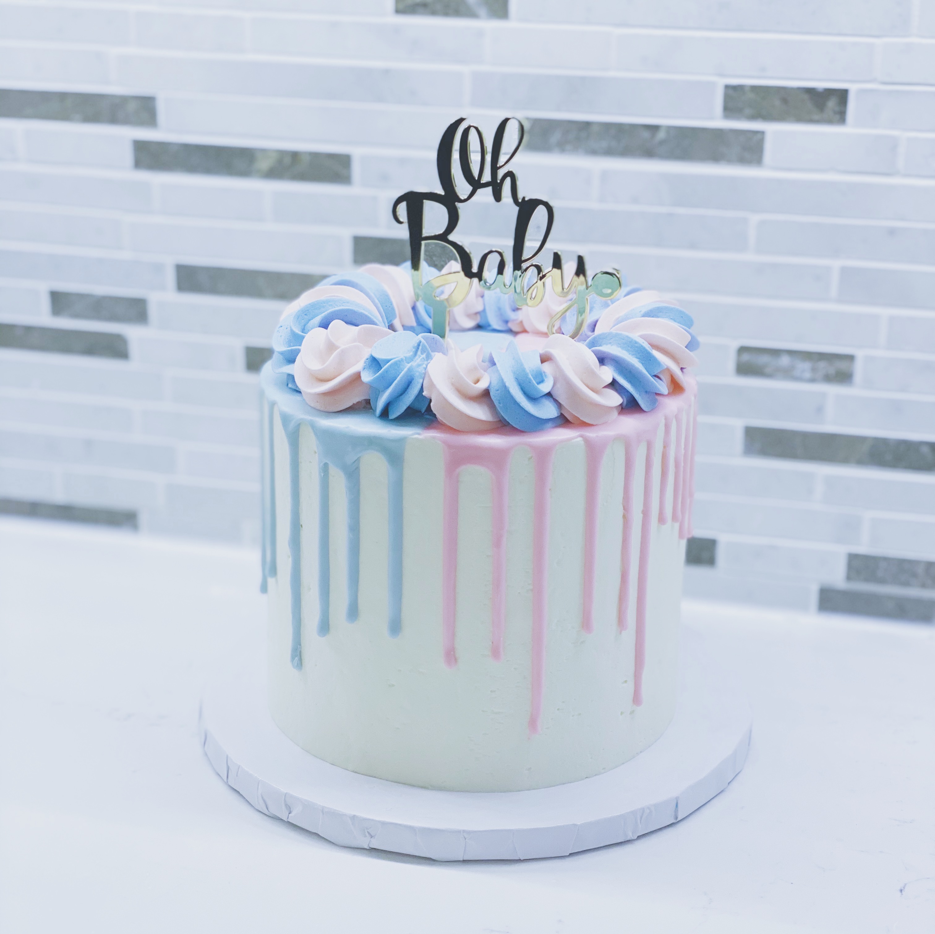 Blue and pink drip cake with cake topper
