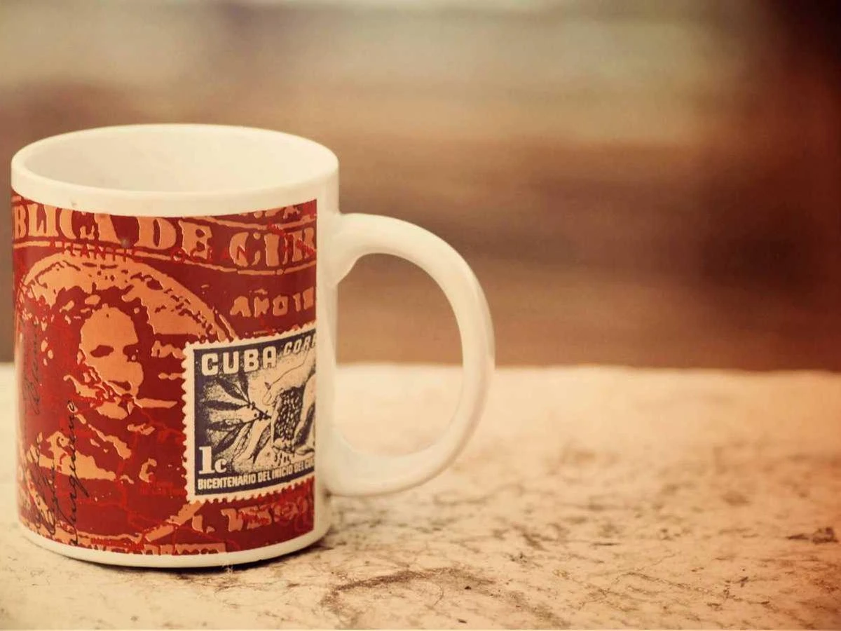 A vintage red diner mug on a wooden table