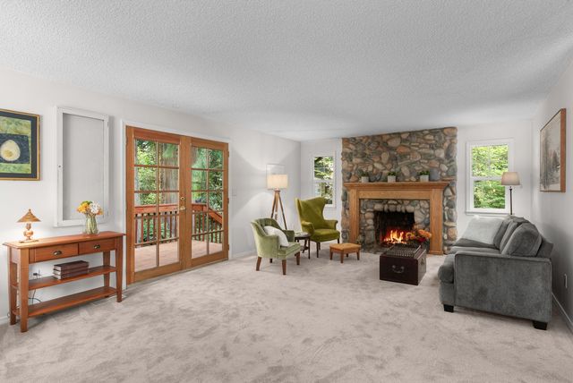 Spacious living room with beautiful river rock fireplace.
