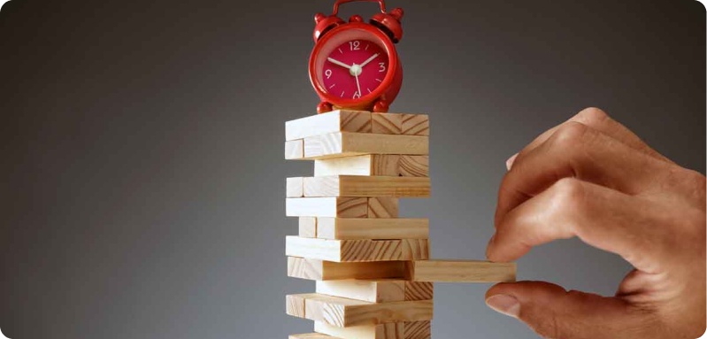 An alarm clock on top of stacked wooden blocks