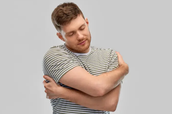 A man hugging himself