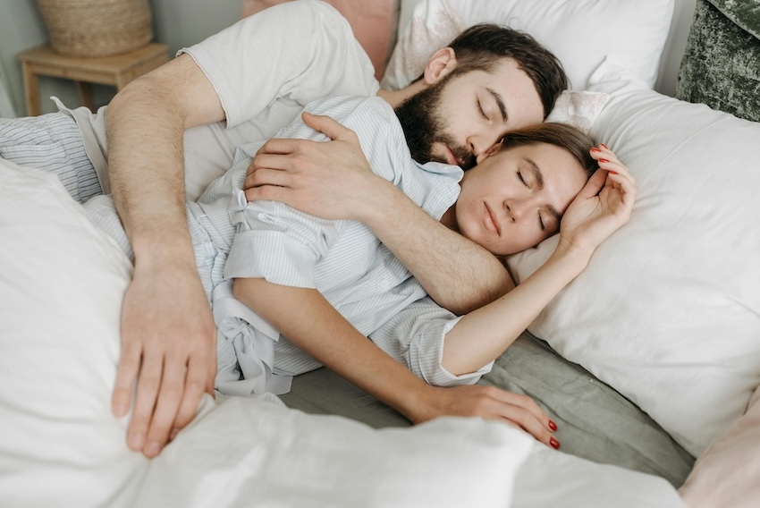 Two People Embracing in Bed