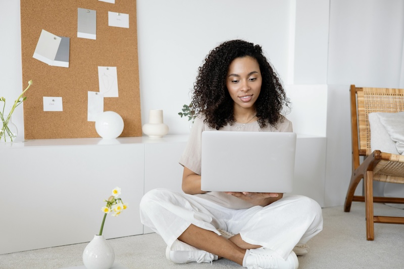 A woman using a laptop exploring embraceclub.com