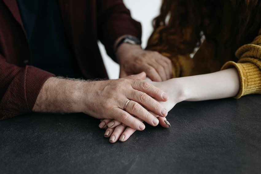 Supportive Older Hands Comforting Younger