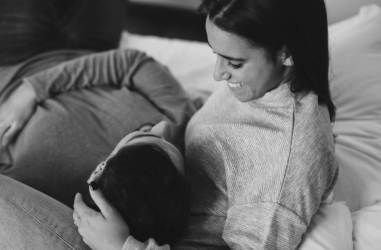 Two people cuddling on the couch