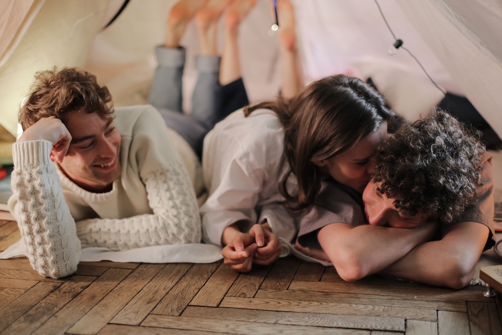 Adults gathered together at a cuddle party, fully clothed