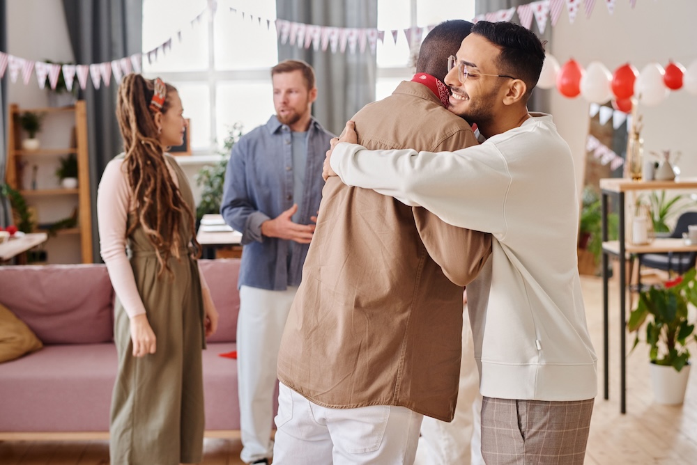Friends hugging at a cuddle party, fully clothed